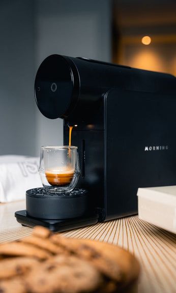 Artisan Coffee co black morning machine with biscuits in foreground
