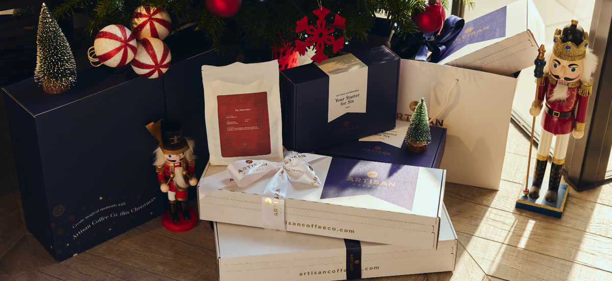 An open white gift box sitting on a table in a nicely set living room