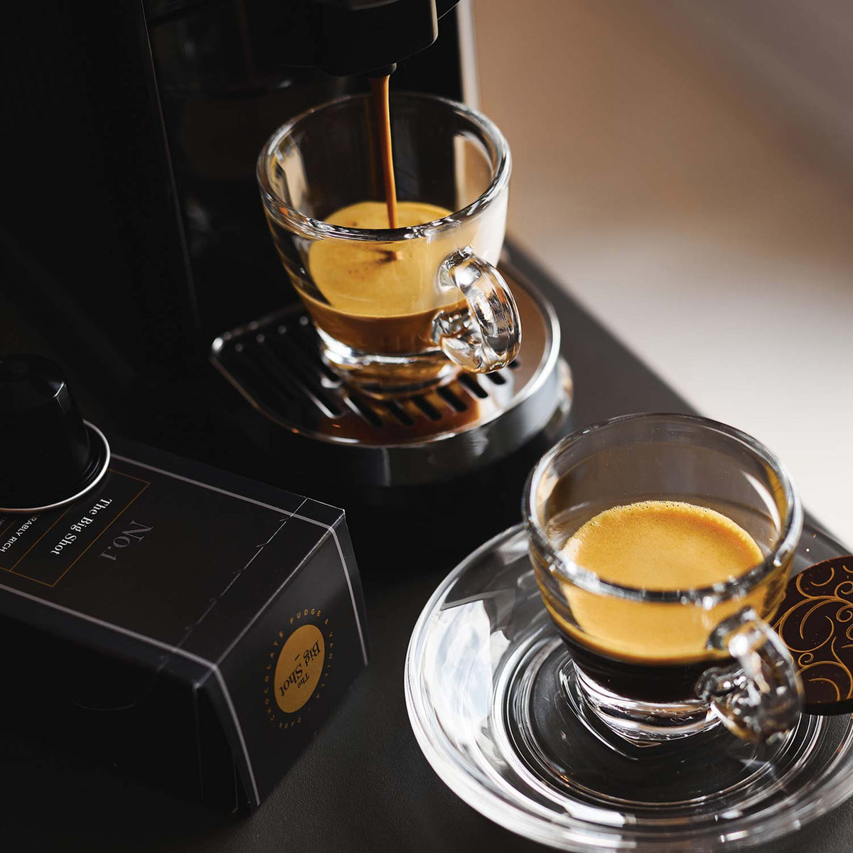 The Big Shot Nespresso Compatible Coffee Pods with coffee pouring from a pod machine