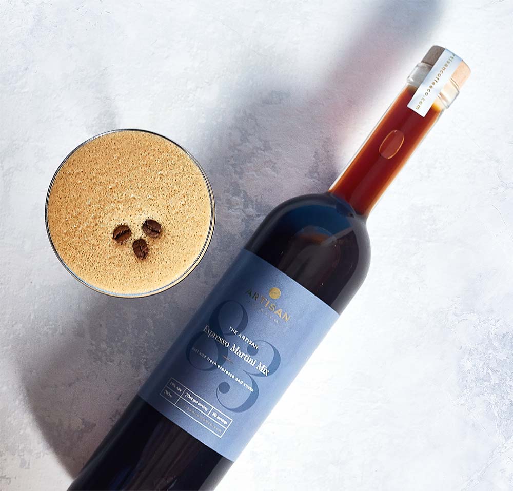 The Artisan Coffee Co Espresso Martini Mix with an espresso martini and coffee beans floating on top