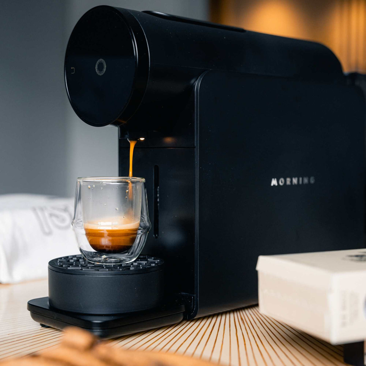 Morning Pod Machine in black pouring coffee