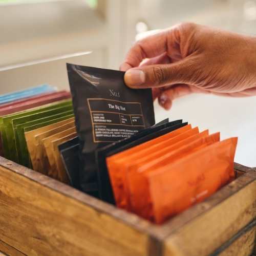 Selecting The Big Shot Coffee from a selection of coffee bags